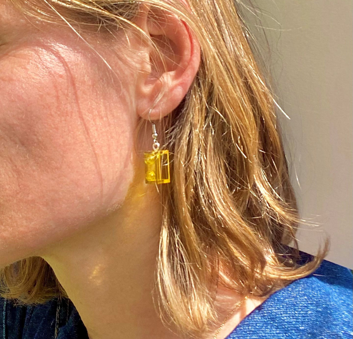 Boucles d'oreilles pendantes jaunes en Lego, apportant une touche de couleur et de style moderne.
