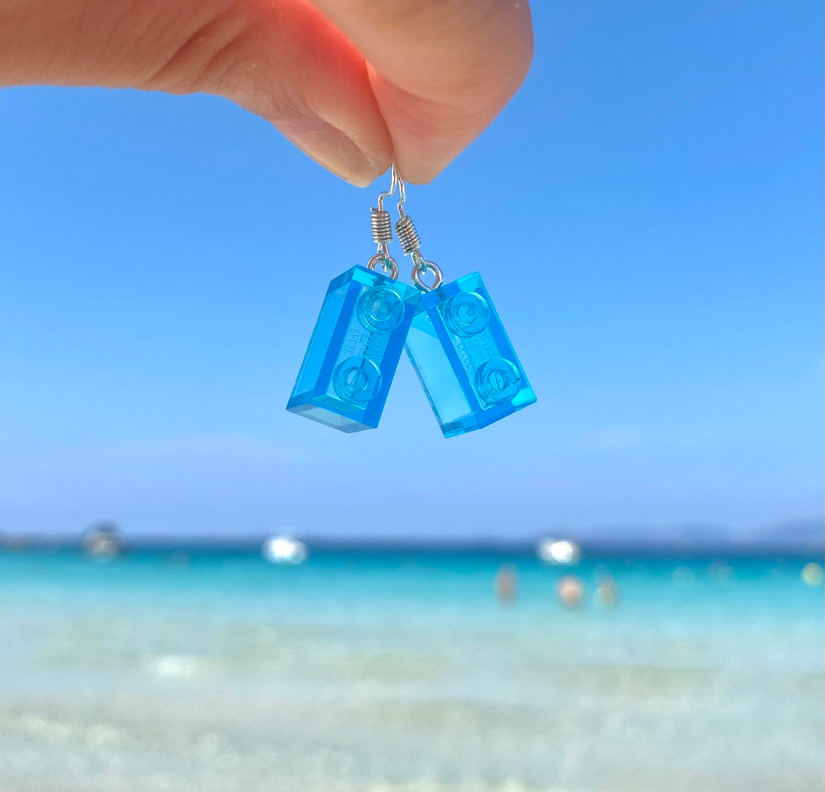 Boucles d'oreilles pendantes en brique Lego® bleu, parfaites pour compléter vos looks estivaux à la plage.