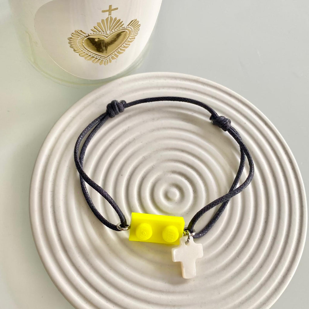 Bracelet mixte garçon ou fille à offrir en cadeau de 1ère Communion ou profession de Foi avec une brique de Lego jaune fluo authentique et une croix nacrée. Un cadeau pas cher à moins de 15€.